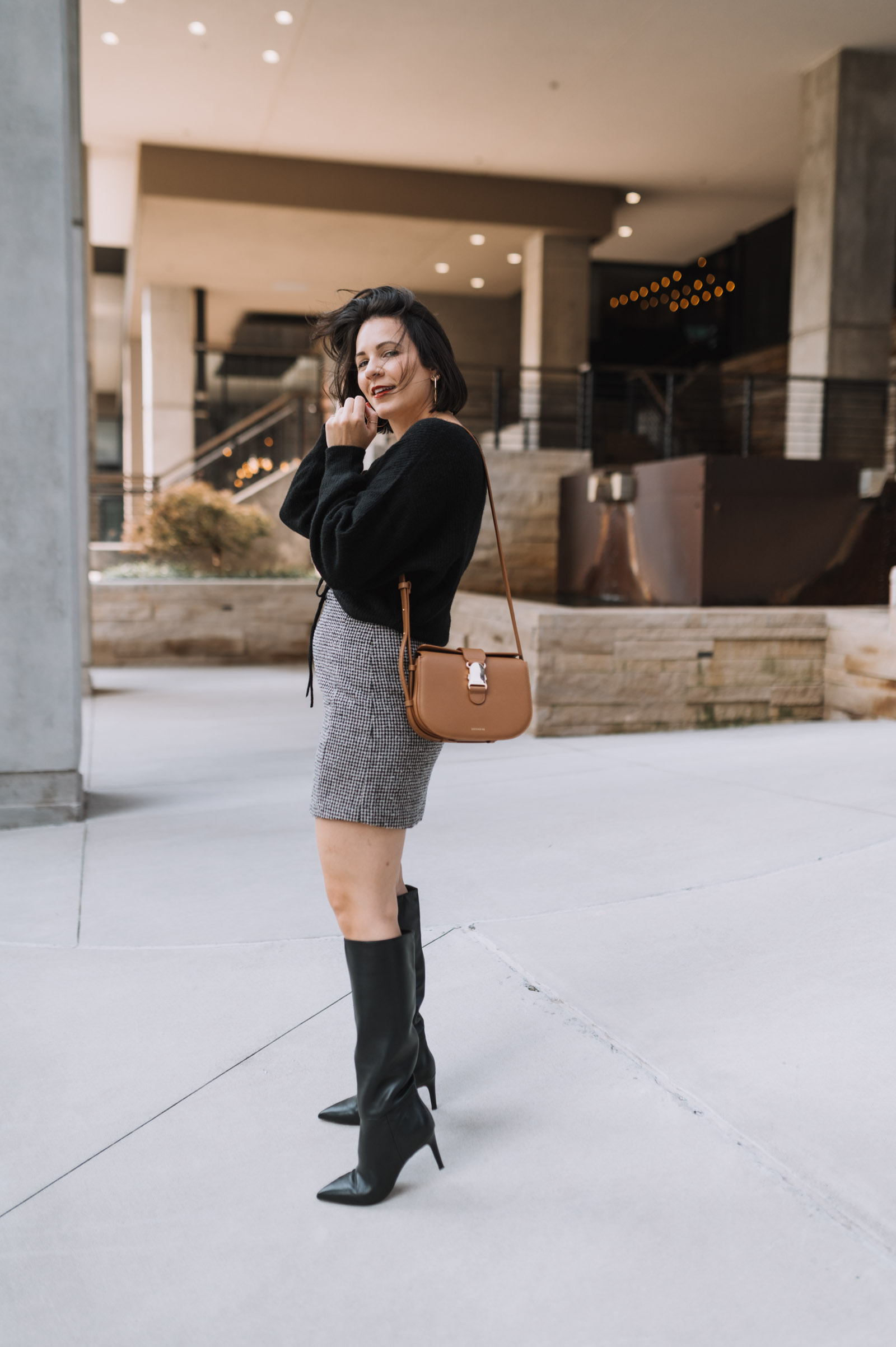 black nee high boots with a mini skirt