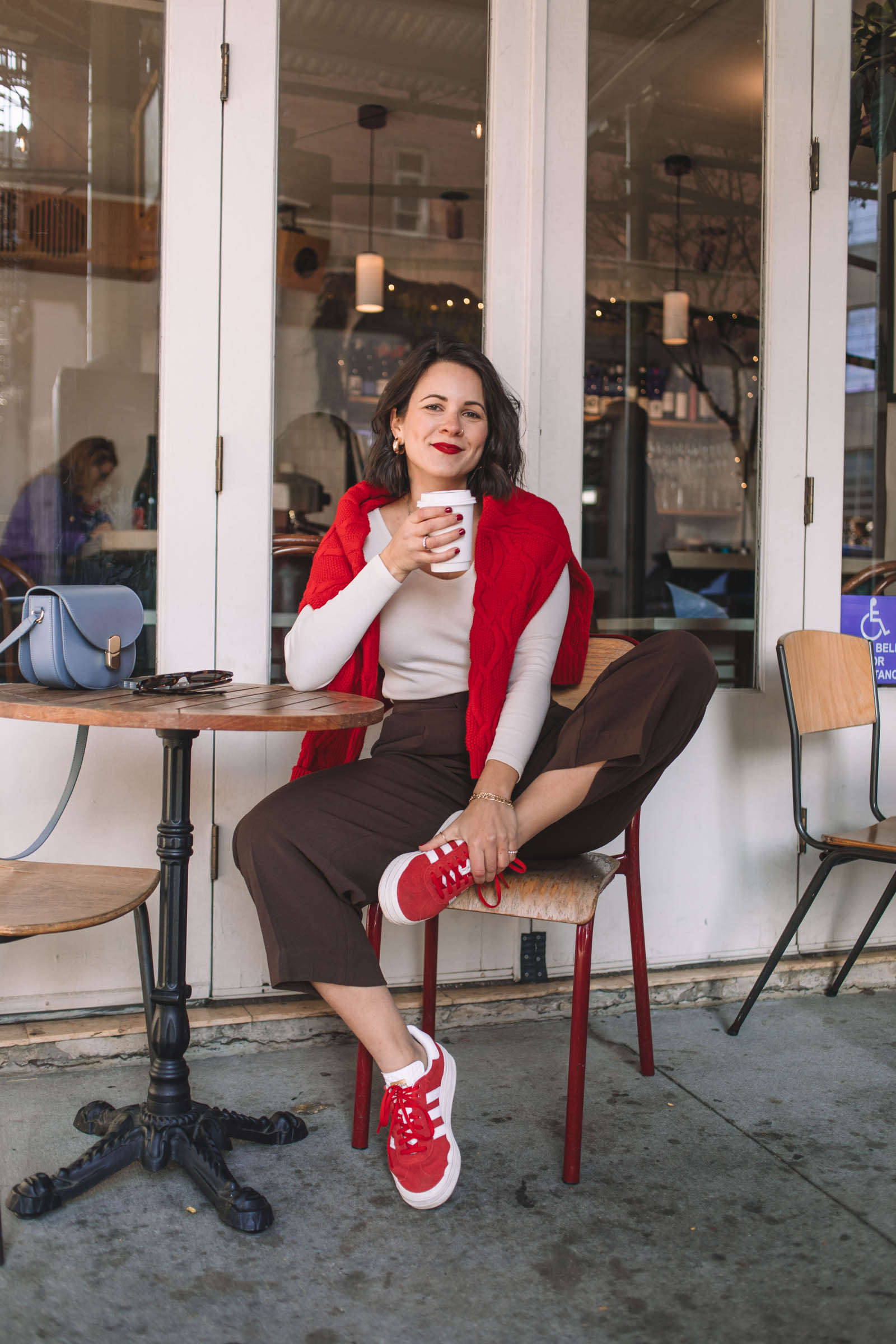 red sweater and brown trousers
